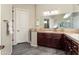 Bathroom features a large vanity with dual sinks, dark wood cabinets, and a large mirror at 13072 W Alyssa Ln, Peoria, AZ 85383