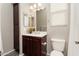 Bathroom featuring a single sink vanity, mirrored medicine cabinet, and toilet at 13072 W Alyssa Ln, Peoria, AZ 85383