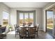 Bright dining room with a round table, seating for six and large windows offering scenic views at 13072 W Alyssa Ln, Peoria, AZ 85383