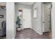 Bright entryway with wood flooring, a white front door, and a view into the home at 13072 W Alyssa Ln, Peoria, AZ 85383