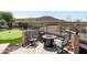 Outdoor fire pit with seating and putting green against desert views at 13072 W Alyssa Ln, Peoria, AZ 85383