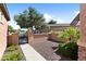 Charming front courtyard with decorative gravel, mature trees, and a paved walkway at 13072 W Alyssa Ln, Peoria, AZ 85383