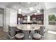 Modern kitchen with a granite island, breakfast bar seating, pendant lights and stainless steel appliances at 13072 W Alyssa Ln, Peoria, AZ 85383