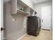 Laundry room features tile floors, utility shelves, and a large washer and dryer at 13072 W Alyssa Ln, Peoria, AZ 85383