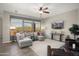 Spacious living room featuring a comfortable sectional sofa, large windows, and a modern aesthetic at 13072 W Alyssa Ln, Peoria, AZ 85383