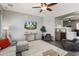 Inviting living room featuring a ceiling fan, modern furniture, neutral tones and decorative shelving at 13072 W Alyssa Ln, Peoria, AZ 85383