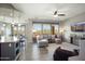 Open living room with modern decor, large windows, and seamless flow into the dining area at 13072 W Alyssa Ln, Peoria, AZ 85383