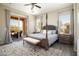 Serene main bedroom with a four-poster bed, neutral tones, slider to patio, and ample natural light at 13072 W Alyssa Ln, Peoria, AZ 85383