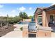 Backyard with built-in BBQ and bar area, putting green, and jacuzzi at 13072 W Alyssa Ln, Peoria, AZ 85383