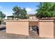 View of the pool equipment enclosure with mature trees and a desert landscape in the background at 13072 W Alyssa Ln, Peoria, AZ 85383