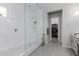 Bathroom featuring a frameless glass shower and entry to walk-in closet at 14360 W Windrose Dr, Surprise, AZ 85379