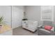 Bedroom featuring white crib, closet, and grey rocking chair at 14360 W Windrose Dr, Surprise, AZ 85379