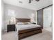 This bedroom features a wood bed frame and barn door entry to the bathroom at 14360 W Windrose Dr, Surprise, AZ 85379