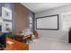 Well-appointed bonus room with a piano, workspace, and framed movie screen at 14360 W Windrose Dr, Surprise, AZ 85379