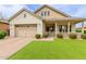 Charming single-Gathering home featuring a welcoming front porch, desert landscaping, and a two-car garage at 14360 W Windrose Dr, Surprise, AZ 85379