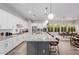 Spacious kitchen view highlighting a large island bar, sink, and dining area in an open floorplan at 14360 W Windrose Dr, Surprise, AZ 85379