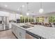 Open kitchen view showcasing the island, stainless steel appliances, and dining area at 14360 W Windrose Dr, Surprise, AZ 85379