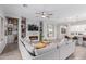 Open-concept living area with a stylish fireplace, TV, and seamless flow to the kitchen at 14360 W Windrose Dr, Surprise, AZ 85379