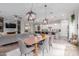 Open-concept living space with a dining area, modern kitchen, living room, and decorative lighting at 14360 W Windrose Dr, Surprise, AZ 85379