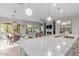 Open-concept living space with island seating flowing seamlessly into the dining and Gathering rooms at 14360 W Windrose Dr, Surprise, AZ 85379
