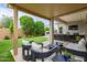 Inviting outdoor space with a covered patio, modern seating, and a built-in bar area perfect for entertaining at 14360 W Windrose Dr, Surprise, AZ 85379