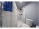 Shot of shower with blue towel and a white shower curtain, with marble style shower interior at 14412 N 39Th Ave, Phoenix, AZ 85053