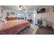 Bedroom with hard surface floors, accent rug, ceiling fan, fireplace and ensuite bathroom at 14412 N 39Th Ave, Phoenix, AZ 85053