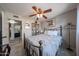Bedroom with blue bedding, carpet, ceiling fan, and ensuite bathroom access at 14412 N 39Th Ave, Phoenix, AZ 85053