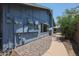 Exterior view along rock garden showing the side of the blue house, utility boxes and pathway at 14412 N 39Th Ave, Phoenix, AZ 85053
