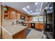 Bright kitchen with wood cabinetry, stainless steel appliances and a skylight for natural light at 14412 N 39Th Ave, Phoenix, AZ 85053