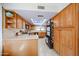 Charming kitchen with light wood cabinets, granite countertops, a skylight, and modern stainless steel appliances at 14412 N 39Th Ave, Phoenix, AZ 85053