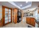 Kitchen with wood cabinets, tiled floors, and open view to living space, and sunroom at 14412 N 39Th Ave, Phoenix, AZ 85053