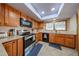 Well-lit kitchen featuring wood cabinets, stainless steel appliances and tiled floors at 14412 N 39Th Ave, Phoenix, AZ 85053