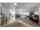 Bright living room with stylish furniture, neutral paint colors, and connecting dining and fireplace spaces at 14412 N 39Th Ave, Phoenix, AZ 85053
