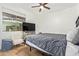Neutral bedroom with a gray comforter, white chair, and a dresser with a television on top at 16609 N 40Th Dr, Phoenix, AZ 85053