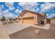 Three-car garage with driveway, providing ample parking space and convenient access to the home at 16609 N 40Th Dr, Phoenix, AZ 85053