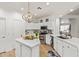 Well-lit kitchen features stainless steel appliances, white cabinets, and quartz countertops at 16609 N 40Th Dr, Phoenix, AZ 85053