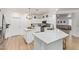 Spacious kitchen with white cabinets, quartz countertops, and open access to living area at 16609 N 40Th Dr, Phoenix, AZ 85053