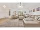 Spacious living room with hardwood floors, a large sectional sofa, and plenty of natural light at 16609 N 40Th Dr, Phoenix, AZ 85053