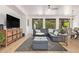 Spacious living room with large sectional sofa, modern rug, and plenty of natural light at 16609 N 40Th Dr, Phoenix, AZ 85053