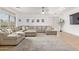 Large and bright living room with hardwood floors, ceiling fan and a spacious sectional sofa at 16609 N 40Th Dr, Phoenix, AZ 85053