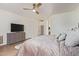 Bright and spacious main bedroom features a large bed and a light wood grain dresser with a TV at 16609 N 40Th Dr, Phoenix, AZ 85053