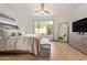 Bright main bedroom featuring a large window, ceiling fan, sitting bench, and spacious layout at 16609 N 40Th Dr, Phoenix, AZ 85053