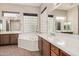 Well-lit bathroom features a tub, white counter tops, and tile flooring at 16704 W Oracle Rim Dr, Surprise, AZ 85387