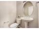 Small half-bath features a toilet, sink, and neutral decor at 16704 W Oracle Rim Dr, Surprise, AZ 85387