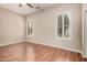Inviting bedroom with hardwood flooring and shuttered windows providing natural light at 16704 W Oracle Rim Dr, Surprise, AZ 85387