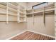 Bright walk-in closet with hardwood floors and custom shelving for optimal storage at 16704 W Oracle Rim Dr, Surprise, AZ 85387