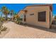 A charming view of a desert home featuring a brick paver walkway, mature plants, and a stucco exterior at 16704 W Oracle Rim Dr, Surprise, AZ 85387