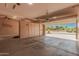 Spacious garage showcasing ample storage cabinets and a partially open door to the neighborhood at 16704 W Oracle Rim Dr, Surprise, AZ 85387