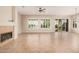 Spacious living room with tile flooring, fireplace, and large windows providing ample natural light at 16704 W Oracle Rim Dr, Surprise, AZ 85387